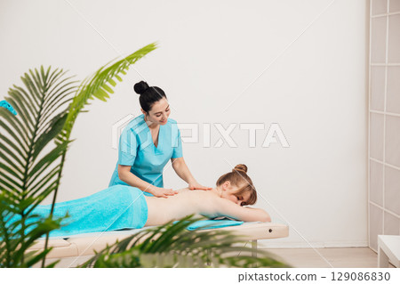 Woman Massage Therapist Doing Medical Back Massage To Woman Woman Massage Therapist Doing Medical Back Massage To Woman 129086830