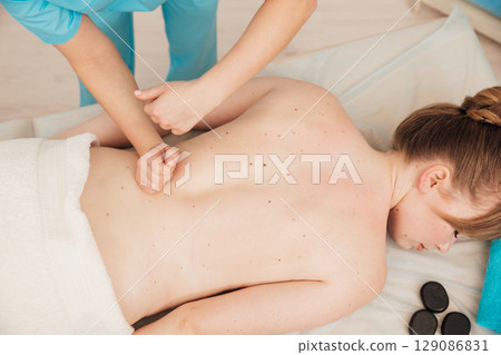 Woman Massage Therapist Doing Medical Back Massage To Woman 129086831