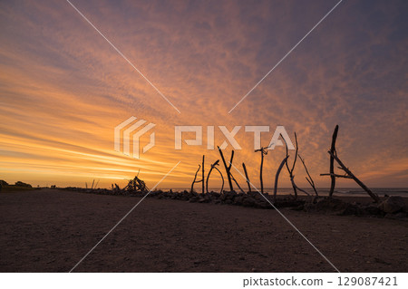 Hokitika beach sign and sunset sky on the West Coast of New Zealand Hokitika beach sign and sunset sky on the West Coast of New Zealand 129087421