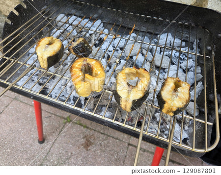 Grilled fish steaks on charcoal grill for summer barbecue party. Grilled sturgeon steaks 129087801