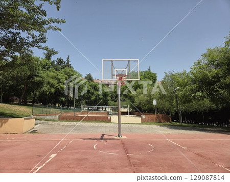 Outdoor basketball court in park on a sunny day for sports and recreation 129087814