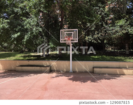 Urban park basketball court under sunny skies 129087815