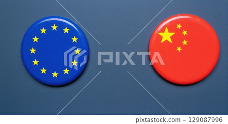 Globe split in China & EU flag symbolizes economic ties, competition in globalization and contrasts cooperation and rivalry 129087996