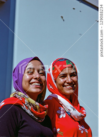 Confident women proudly wear headscarves, embracing cultural identity with warm smiles and graceful dignity 129088234