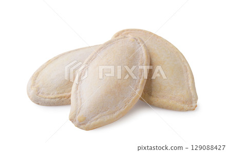 Pumpkin seeds close-up on a white. Isolated 129088427