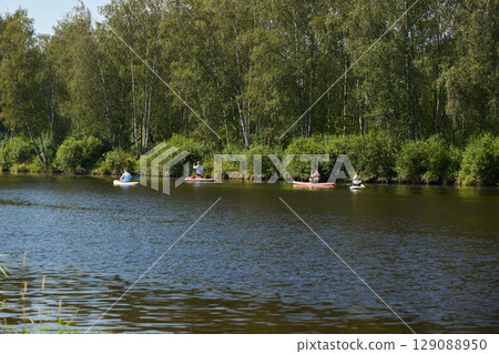 Kayaking on a Beautiful and Serene River Surrounded by Vibrant, Lush Greenery in Nature Kayaking on a Beautiful and Serene River Surrounded by Vibrant, Lush Greenery in Nature 129088950