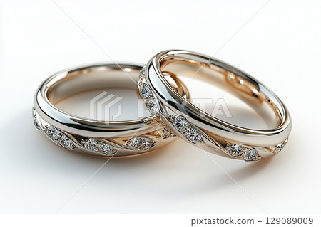 Pair of white gold wedding rings on a white background. Pair of white gold wedding rings on a white background. 129089009