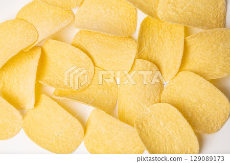 Round corn tortilla chips isolated on white studio background Round corn tortilla chips isolated on white studio background 129089173