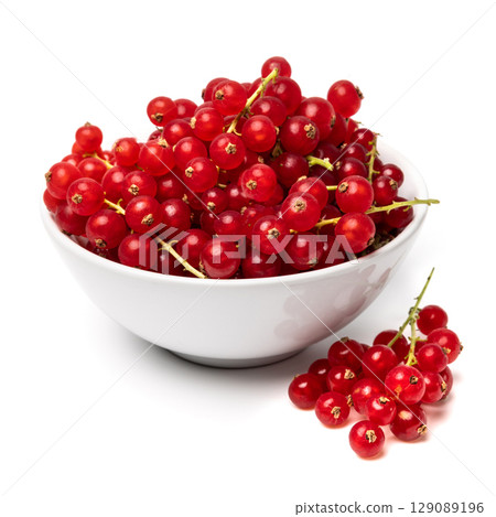 Organic ripe tasty organic berries red currant in ceramic bowl isolated on white studio background 129089196