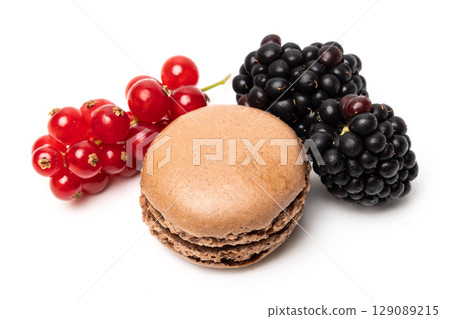 Small tasty sweet original classic macaroon cake with fresh blackberry and redcurrant on top isolated on white studio background 129089215