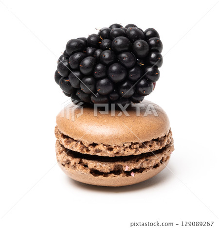 Small tasty sweet original classic macaroon cake with fresh blackberry on top isolated on white studio background 129089267