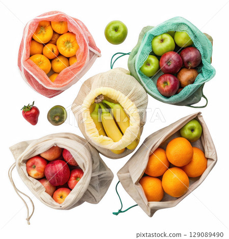 Reusable produce bags filled with fresh fruits including apples, oranges, bananas, and strawberries, promoting eco friendly shopping 129089490