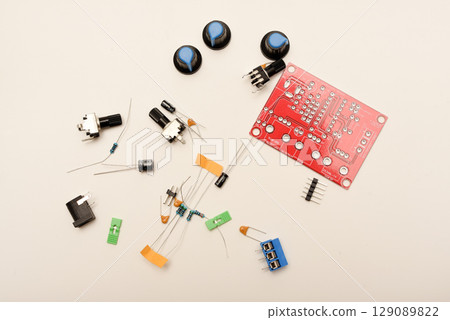 A complete DIY electronics kit for assembling a functional radio device, featuring diverse radio components and a printed circuit board. Perfect image representing the hands-on learning and 129089822