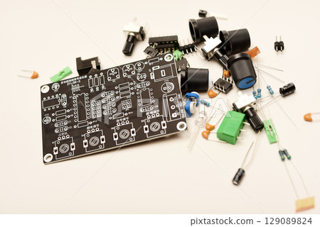 A complete DIY electronics kit for assembling a functional radio device, featuring diverse radio components and a printed circuit board. Perfect image representing the hands-on learning and A complete DIY electronics kit for assembling a functional radio device, featuring diverse radio components and a printed circuit board. Perfect image representing the hands-on learning and 129089824