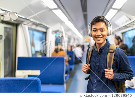 Man wearing headphones on the train 129089840