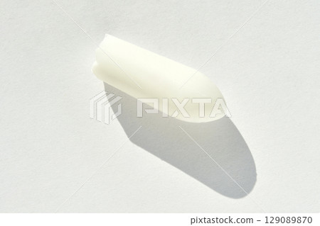 White suppository with shadow on light background highlighting its shape White suppository with shadow on light background highlighting its shape 129089870