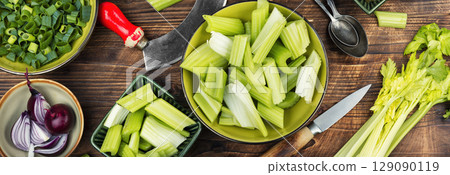 Cut celery sticks and leaves on table. 129090119