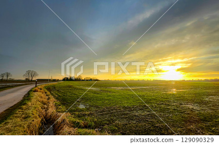 A Beautiful and Serene Sunrise Casting Its Gentle Light Over a Tranquil Field Landscape A Beautiful and Serene Sunrise Casting Its Gentle Light Over a Tranquil Field Landscape 129090329