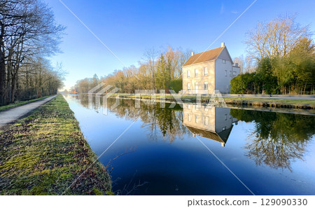 A beautiful and serene reflection of the canal house harmoniously set in natures embrace A beautiful and serene reflection of the canal house harmoniously set in natures embrace 129090330
