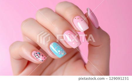 Female hands with pastel nails and pink background Female hands with pastel nails and pink background 129091231