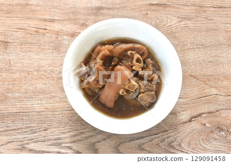 boiled braised salty pork leg in Chinese herb brown soup in bowl  129091458