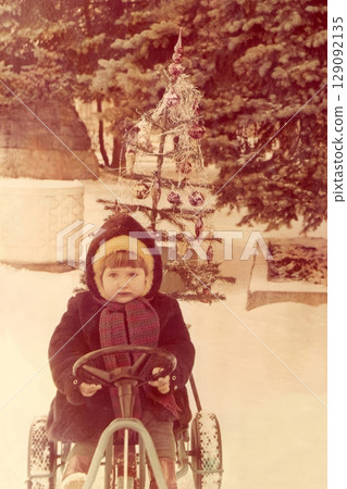 Soviet girl in a fur coat and a fur hat at a christmas Soviet girl in a fur coat and a fur hat at a christmas 129092135