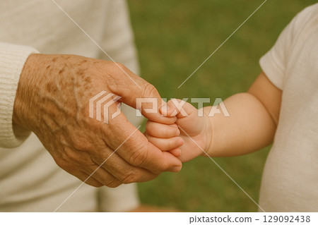 Grandfather and grandson's hands, memories of warmth 129092438