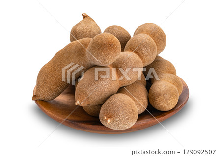 Pile of sweet Tamarind in wooden dish isolated on white background with clipping path. 129092507
