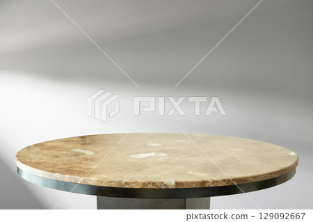 Round marble table top with abstract shadow drop on white wall background for mockup product display 129092667