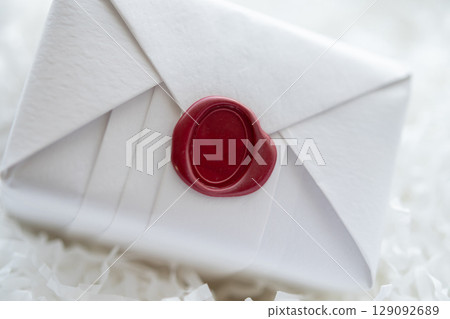 Wax seal stamp on white paper wrap packaging parcel box Wax seal stamp on white paper wrap packaging parcel box 129092689