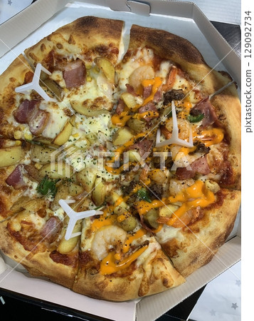 Cheesy pizza topped with golden french fries, combining crispy potato goodness with gooey, savory delight. A fun and indulgent twist on two favorite comfort foods. 129092734