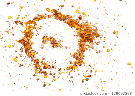 dried red chili pepper flakes and seeds isolated on white background 129092898