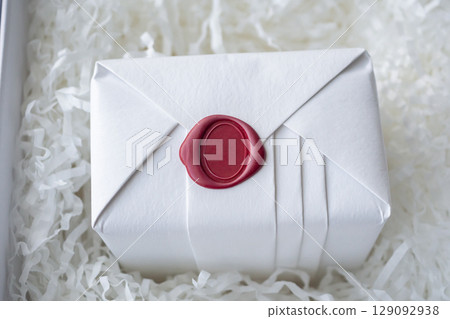 Wax seal stamp on white paper wrap packaging parcel box 129092938