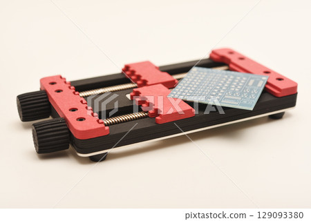 Universal professional holder for circuit boards and microchips. Blue printed circuit board for soldering. 129093380