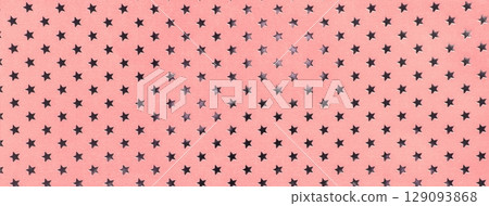 Light pink and rose paper background with metal foil pattern of silver stars for Christmas or New Year backdrop 129093868