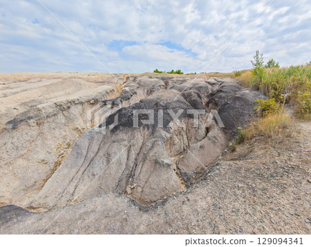 Tailings and waste sand  in  mined open pit coal quarry. Heavy erosion 129094341