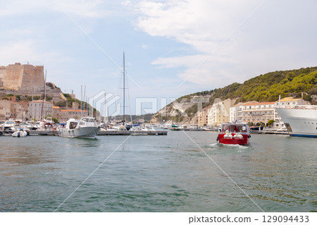 Scenic Harbor View With Boats and Hillside Buildings Under a Clear Sky Scenic Harbor View With Boats and Hillside Buildings Under a Clear Sky 129094433