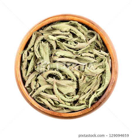 Dried lemon verbena leaves in wooden bowl. Aloysia citrodora, also known as lemon beebrush, used to add lemon flavor to food and beverages, in potpourri, to make herbal teas, and as liqueur flavoring. 129094659