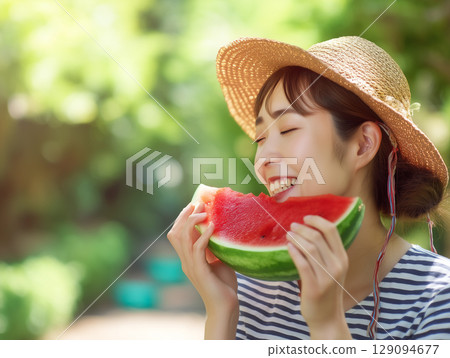 A woman enjoying the flavors of summer | A heartwarming seasonal scene featuring a straw hat and watermelon A woman enjoying the flavors of summer | A heartwarming seasonal scene featuring a straw hat and watermelon 129094677