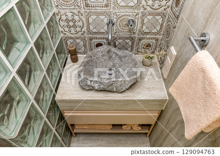 Rustic Bathroom Sink with Stone Basin and Vintage Tiles 129094763