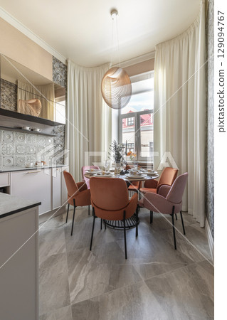 Modern Kitchen Dining Area with Velvet Chairs and Pendant Light 129094767