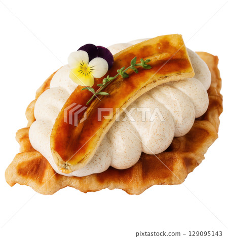 Caramelized banana waffle topped with whipped cream, edible flowers, and thyme for delightful dessert Caramelized banana waffle topped with whipped cream, edible flowers, and thyme for delightful dessert 129095143