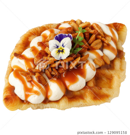 Delicious croffle topped with whipped cream, caramel sauce, nuts, and edible flower creates delightful treat Delicious croffle topped with whipped cream, caramel sauce, nuts, and edible flower creates delightful treat 129095158