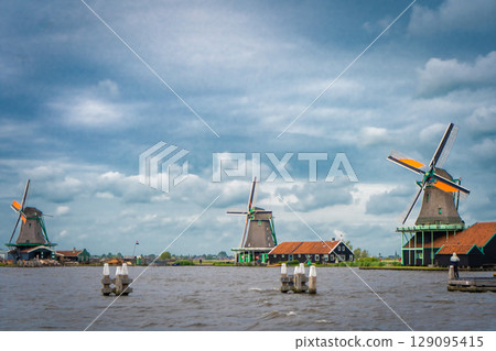 Traditional dutch windmill near the canal. Netherlands Traditional dutch windmill near the canal. Netherlands 129095415