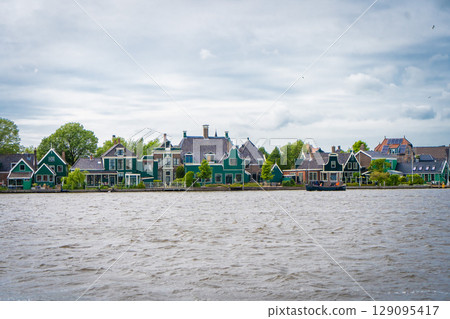 Traditional dutch windmill near the canal. Netherlands Traditional dutch windmill near the canal. Netherlands 129095417