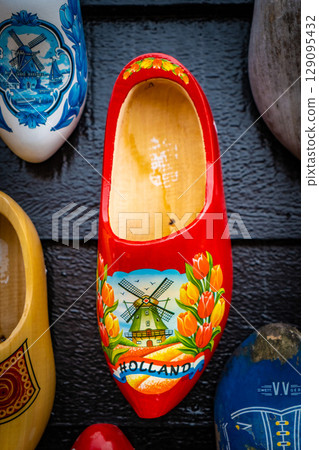 Wooden shoes painted with different regional motifs. Wooden clogs, typical traditional footwear from the Netherlands. 129095432