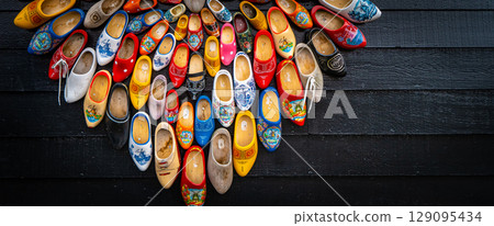 Clogs for sale at a Dutch retail shop. Wooden shoes are a well know traditional souvenir from Holland Clogs for sale at a Dutch retail shop. Wooden shoes are a well know traditional souvenir from Holland 129095434