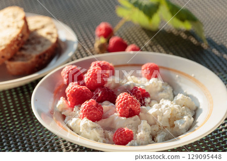 Ricotta or cottage cheese with fresh raspberries. Ricotta or cottage cheese with fresh raspberries. 129095448