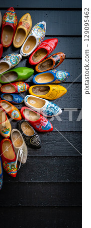 Clogs for sale at a Dutch retail shop. Wooden shoes are a well know traditional souvenir from Holland 129095462