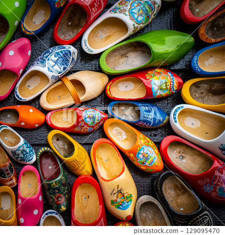 Set of different colorful vintage Dutch wooden clogs 129095470